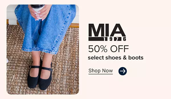 A woman sits holding a cup of coffee and wearing a pair of Mia flats. Mia, 50% off select shoes and boots. Shop now.