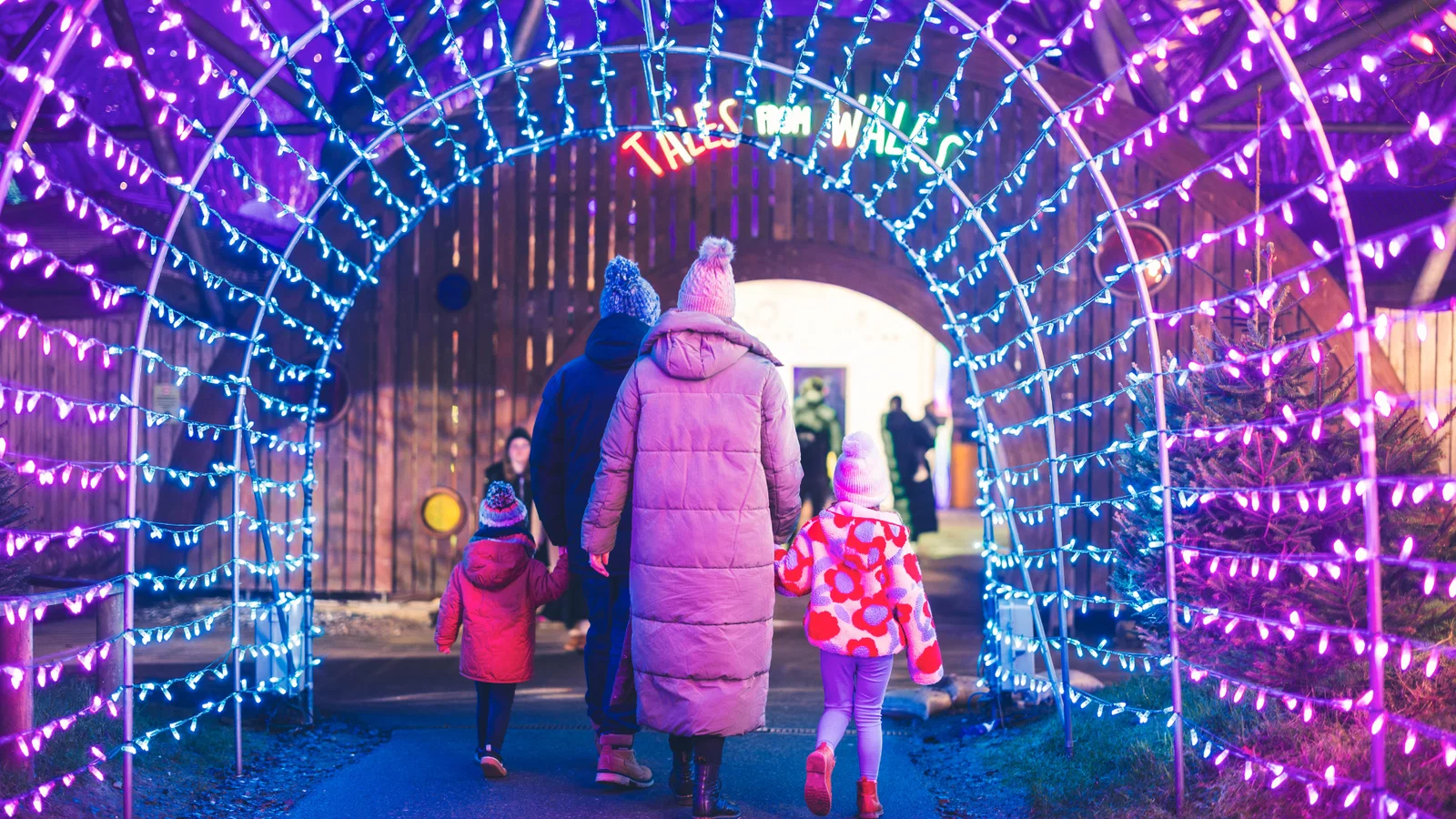 family walking into the tales from wales light trail