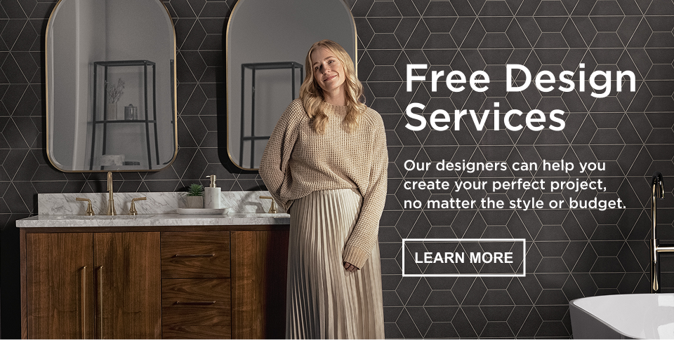 Caption: Free Design Services, our designers can help you create your perfect project, no matter the style or budget, LEARN MORE. Woman smiling in bathroom with black geometric backsplash, double vanity with wood base and marble top, two gold faucets, and two gold mirrors.