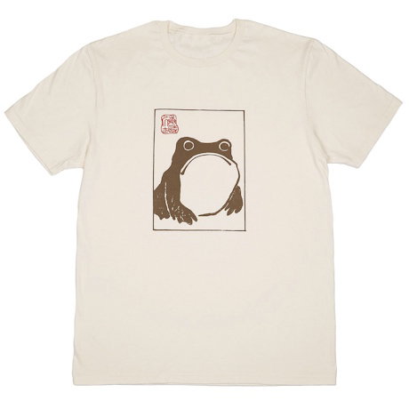 A cotton unisex T-shirt in oat, featuring Matsumoto Hoji’s characterful frog. – Shop Now.