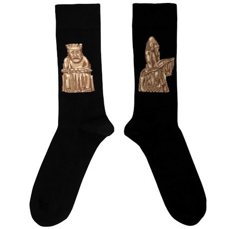 A pair of black men’s socks featuring a design inspired by the iconic Lewis Chessmen. - Shop Now.