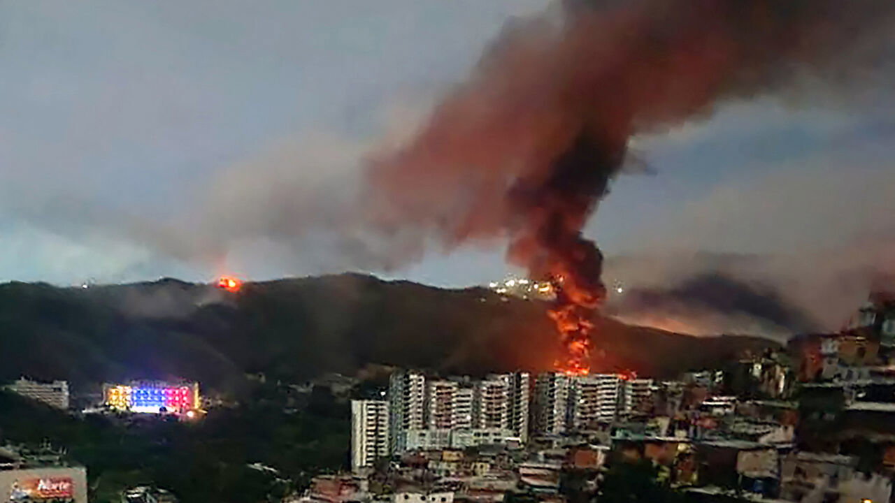 Fire at Fuerte Tiuna, Venezuela's largest military complex is seen from a distance