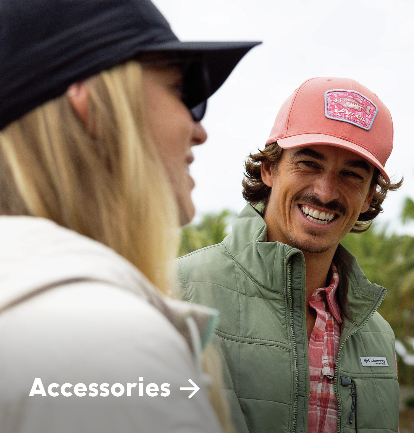Two people sharing a laugh wearing PFG gear