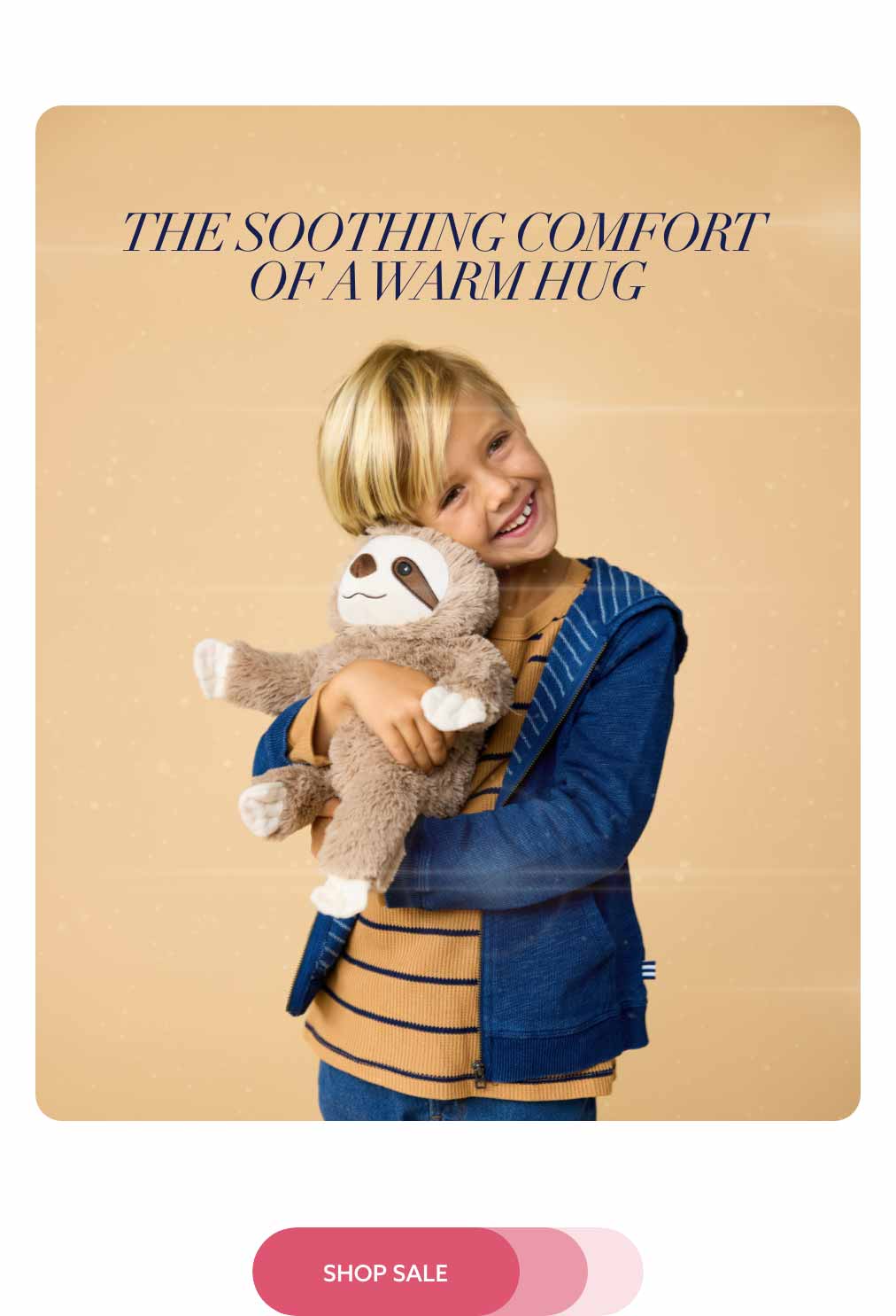 A little boy hugging Sloth Warmies. Shop Sale
