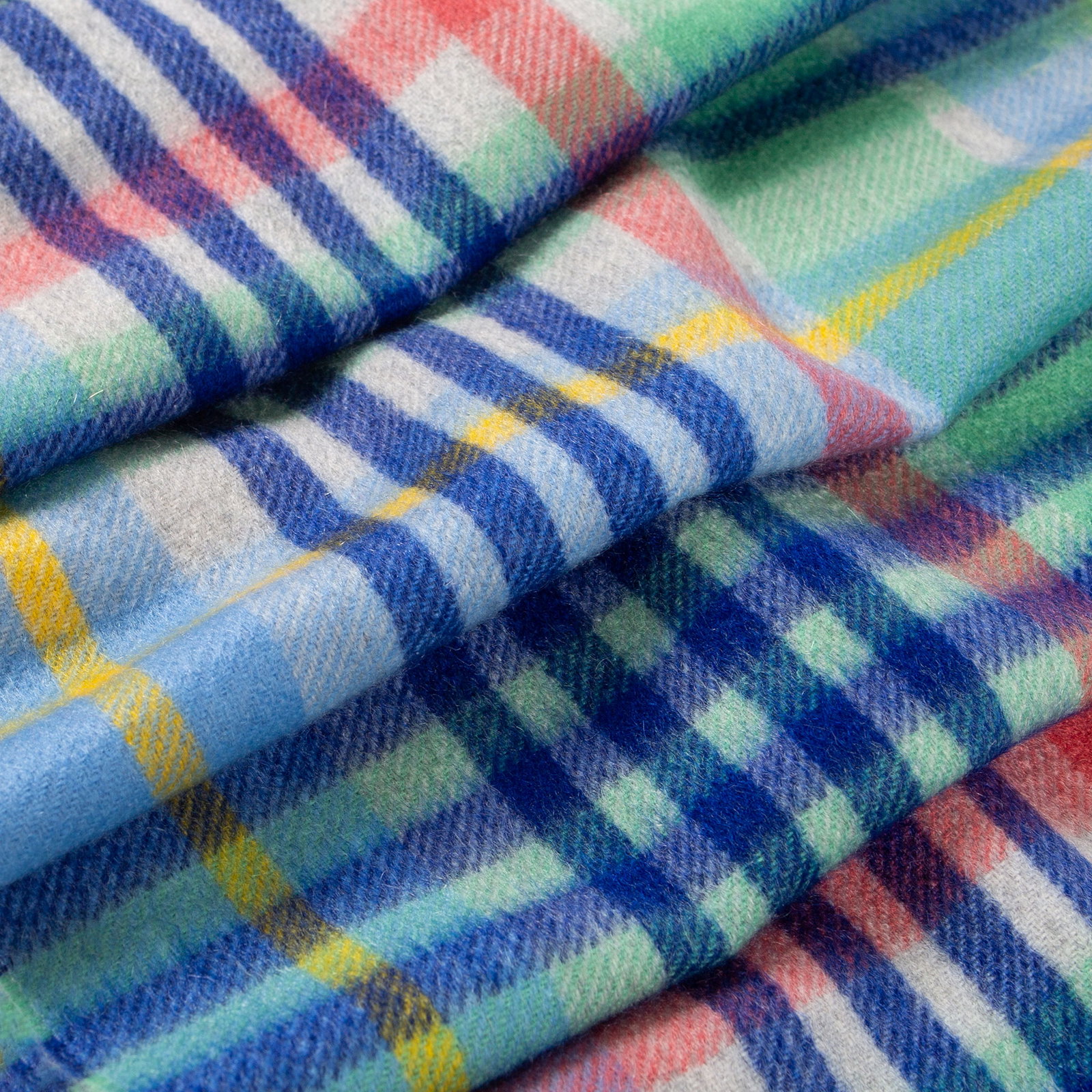Close up of a Plaid Check Cashmere Scarf in coast folded up 