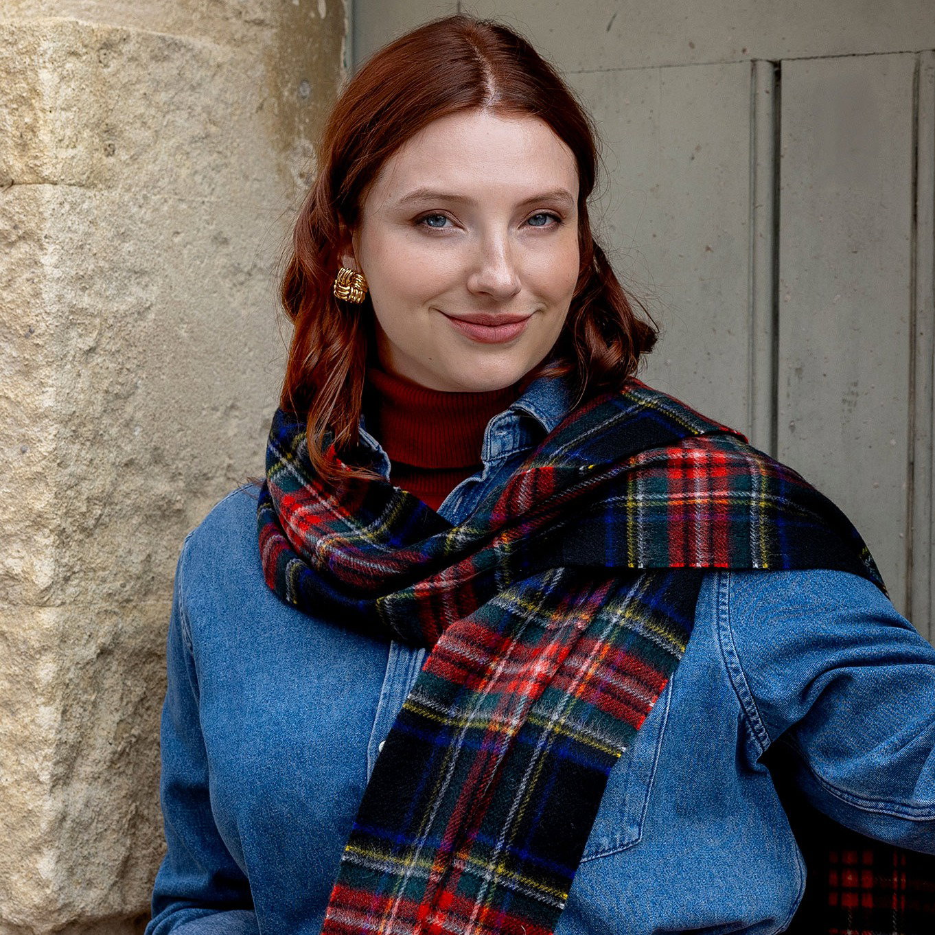 Woman wearing extra large cashmere scarf in black stewart on a walk