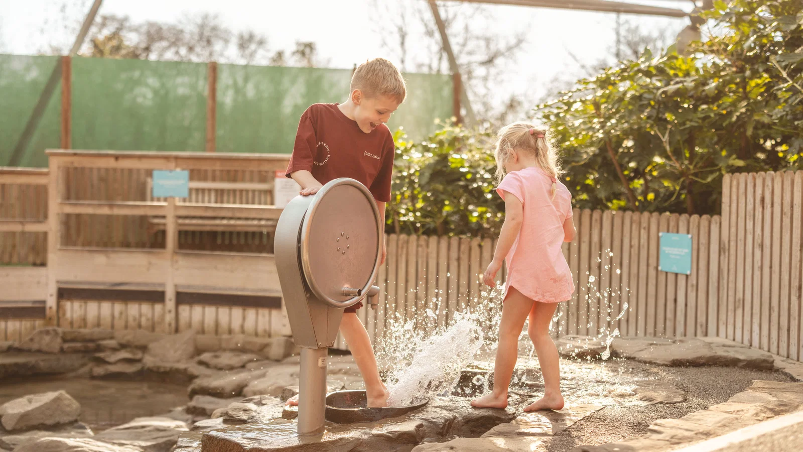 brother and sister at water play