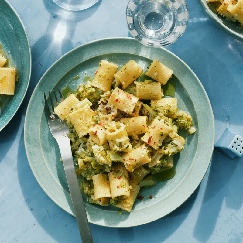 Three bowls of mezze rigatoni tossed broccoli stems in a lemony-anchovy sauce.