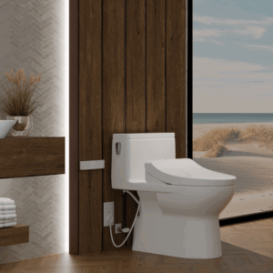 A REDINGTON WASHLET+ One-Piece Skirted Toilet in a sunlit beach-front bathroom beside a wooden floating vanity