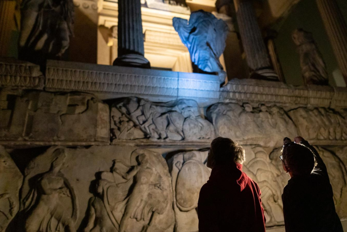Two children exploring the galleries after dark during a sleepover
