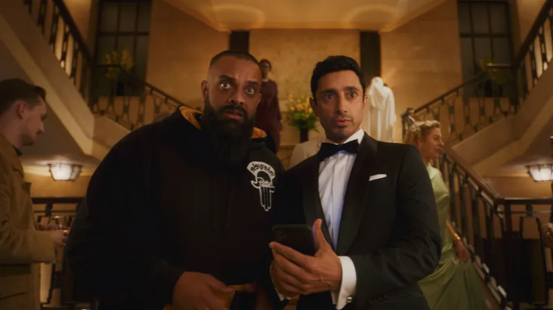 Image may contain: Guz Khan, Riz Ahmed, Clothing, Formal Wear, Suit, Blazer, Coat, Jacket, Tuxedo, Face, Head, and Person