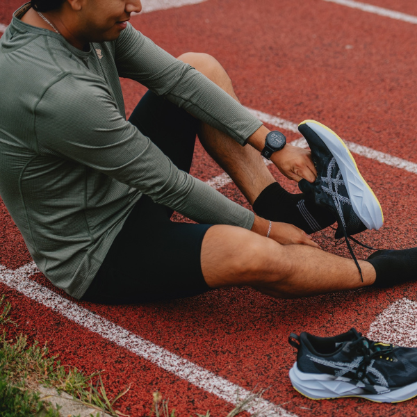 Man putting on ASICS shoes