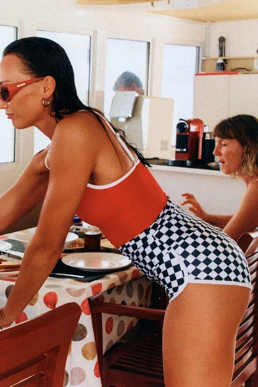 women on a boat wearing checkered shorts