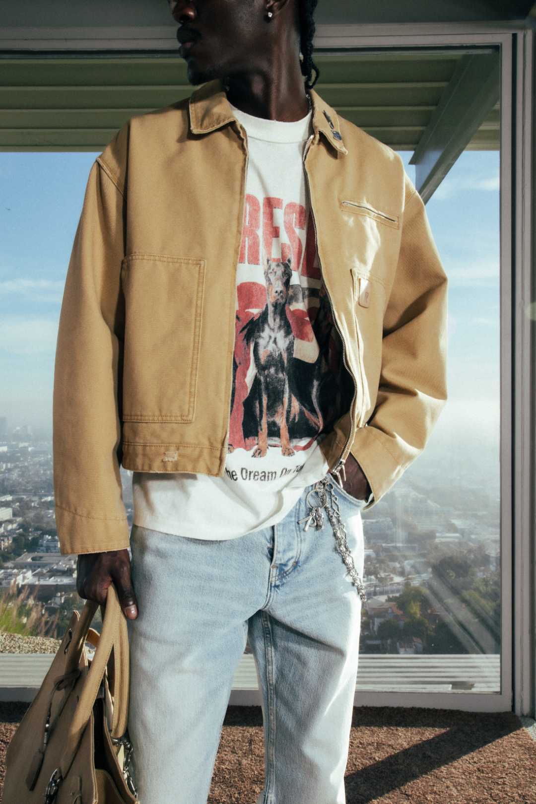 Model wearing the Heaton Workwear Jacket in Irish Cream and the Dream On Tour T-Shirt