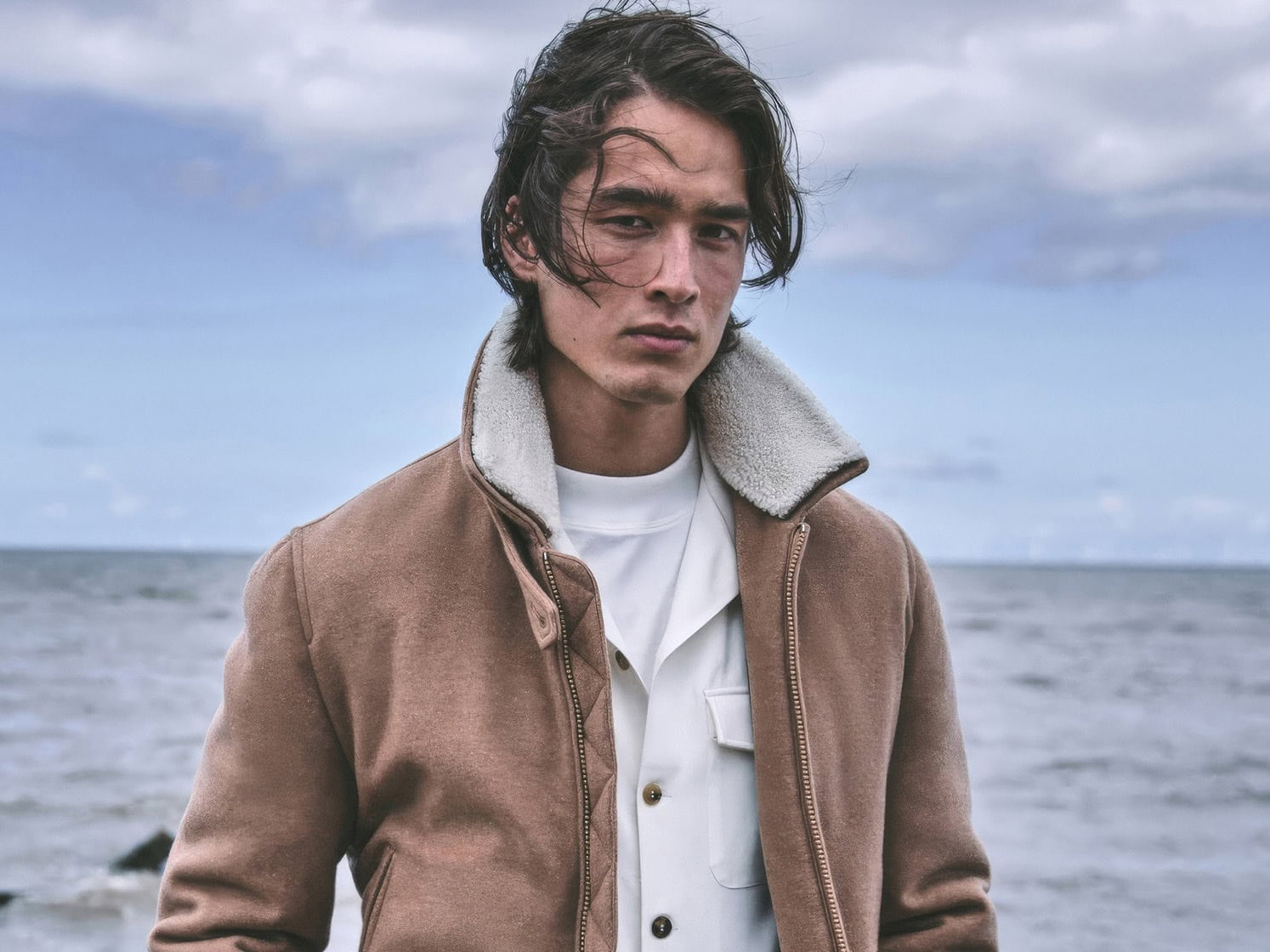 A man wearing a brown jacket