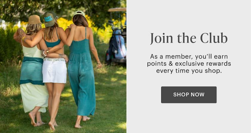 Women on picnic blanket in sandy cove. "Join the club - Shop now"
