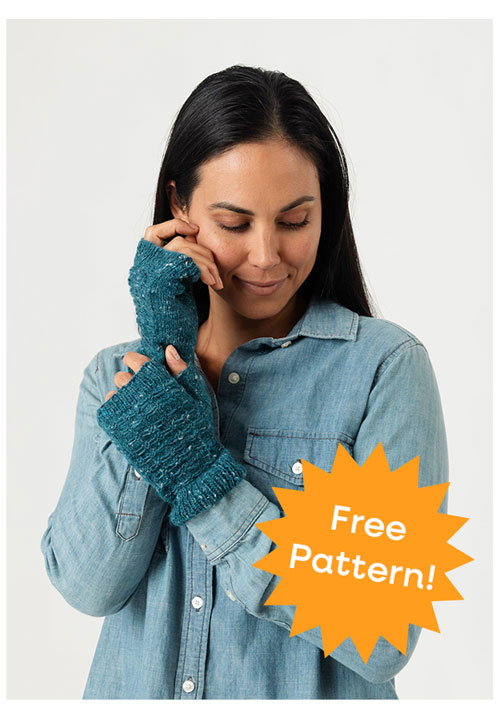 A model wearing a handmade pair of mittens
