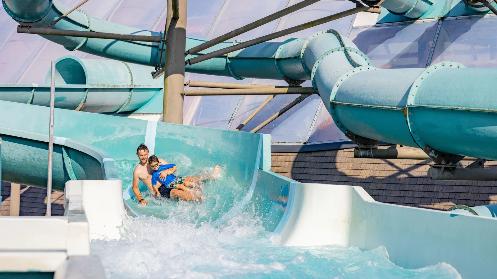 father and son going down water slide