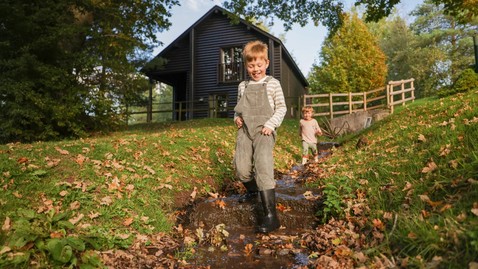 brothers playing outside in autumn