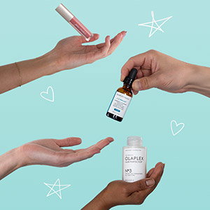 Hands passing makeup, skin care and hair care products to each other
