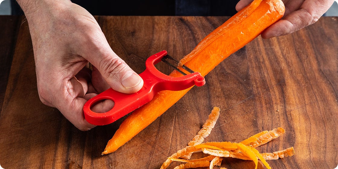 Peeling a carrot with the Kuhn Rikon Original Swiss Peeler