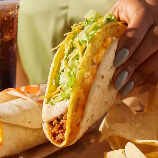 A hand holding a Cheesy Gordita Crunch.