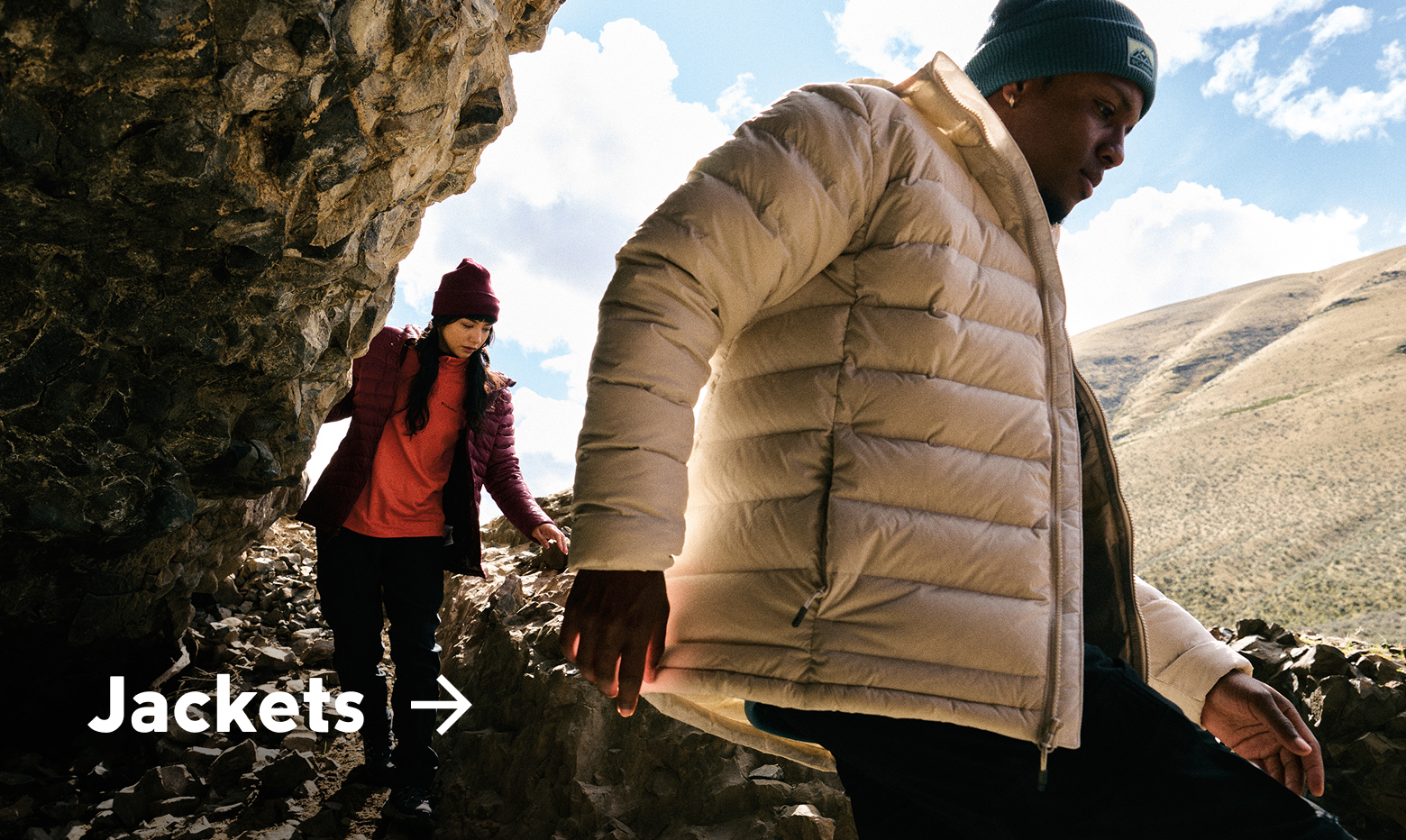 Two hikers exploring a rocky landscape with text: Jackets