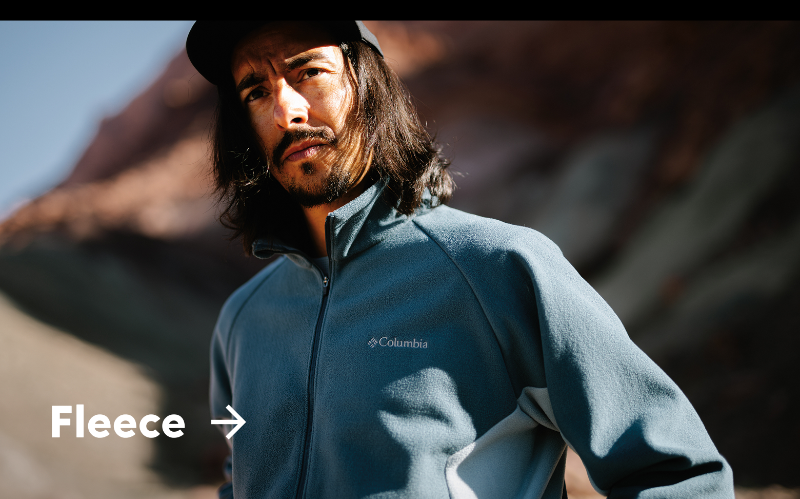 A man wearing a blue fleece jacket with text: Fleece