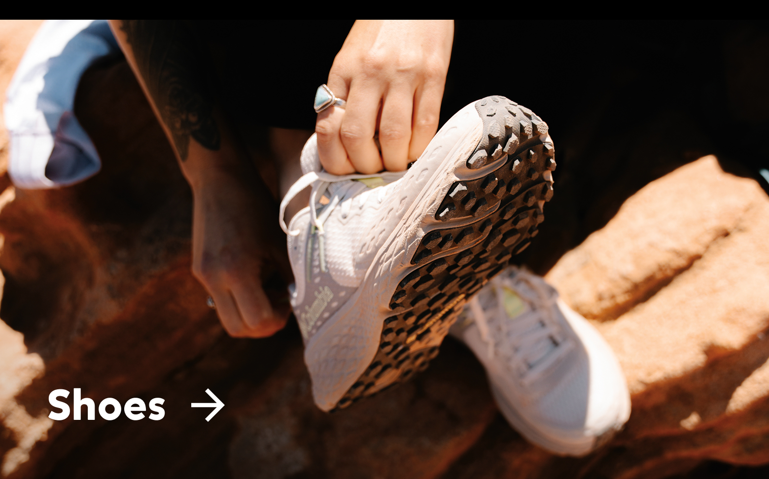 Close-up of a woman's white hiking shoes with text: Shoes
