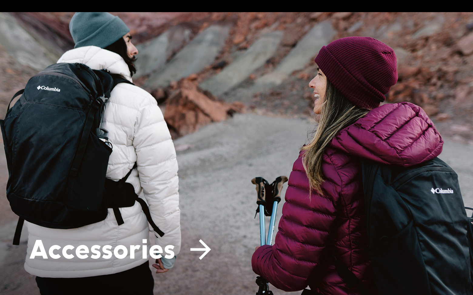 Two women wearing puffer jackets, backpacks, and beanies with text: Accessories
