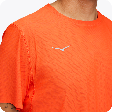 A full body image of a person facing to the left zipping up their GlideTech Top in Faded Navy.  An image of a person posing in HOKA apparel featuring the 2-in-1 Glide Shorts in Midnight Blue. A close up image of a person from the waist down wearing the Race Day Half Tight in Squid Ink. A close up image of a persons chest wearing the Airolite Short Sleeve 2.0 in Lava. A close up image of a person from the back wearing the Race Day Split-Shorts in Squid Ink.