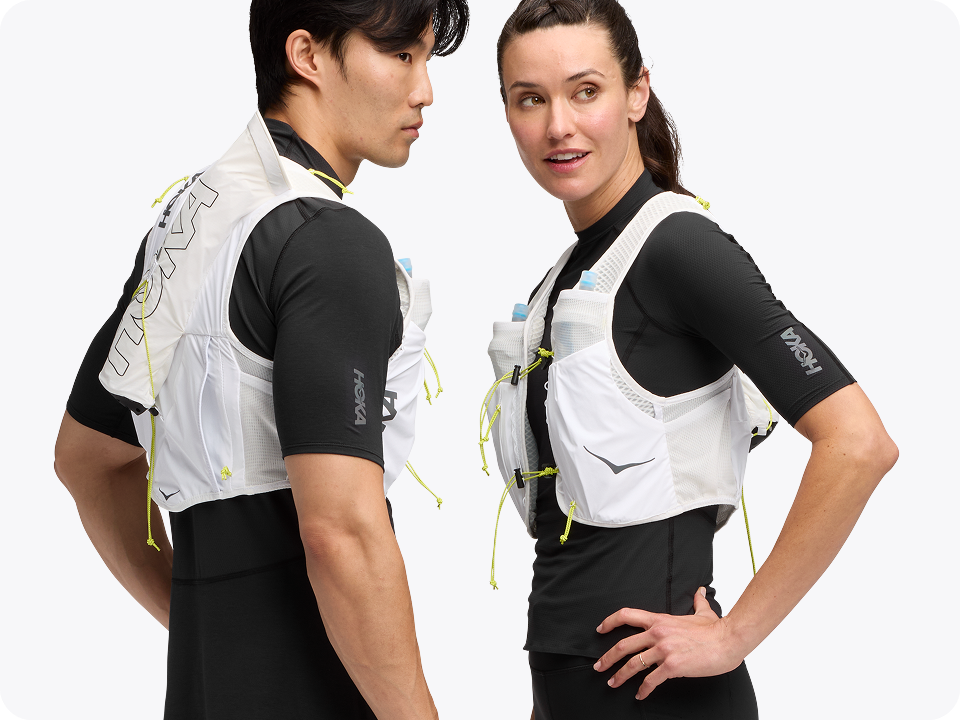 Images of two people posing wearing the Trail Run Vest in White, a person wearing the Airolite Arm Sleeves in HOKA Blue, and a person wearing the Airolite Run Gloves in Black.