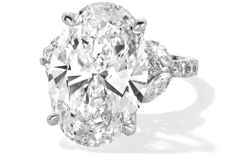Oval cut diamond engagement ring in white gold with marquise shaped diamond side stones.