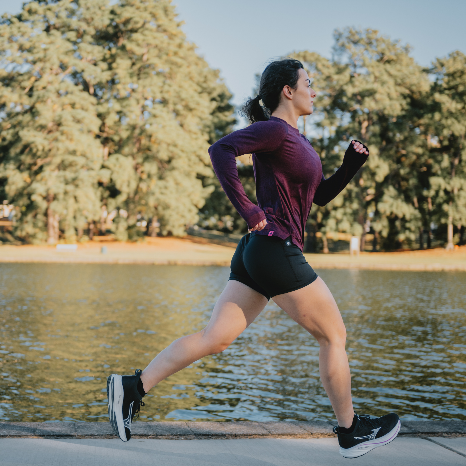 Woman running next to a lake