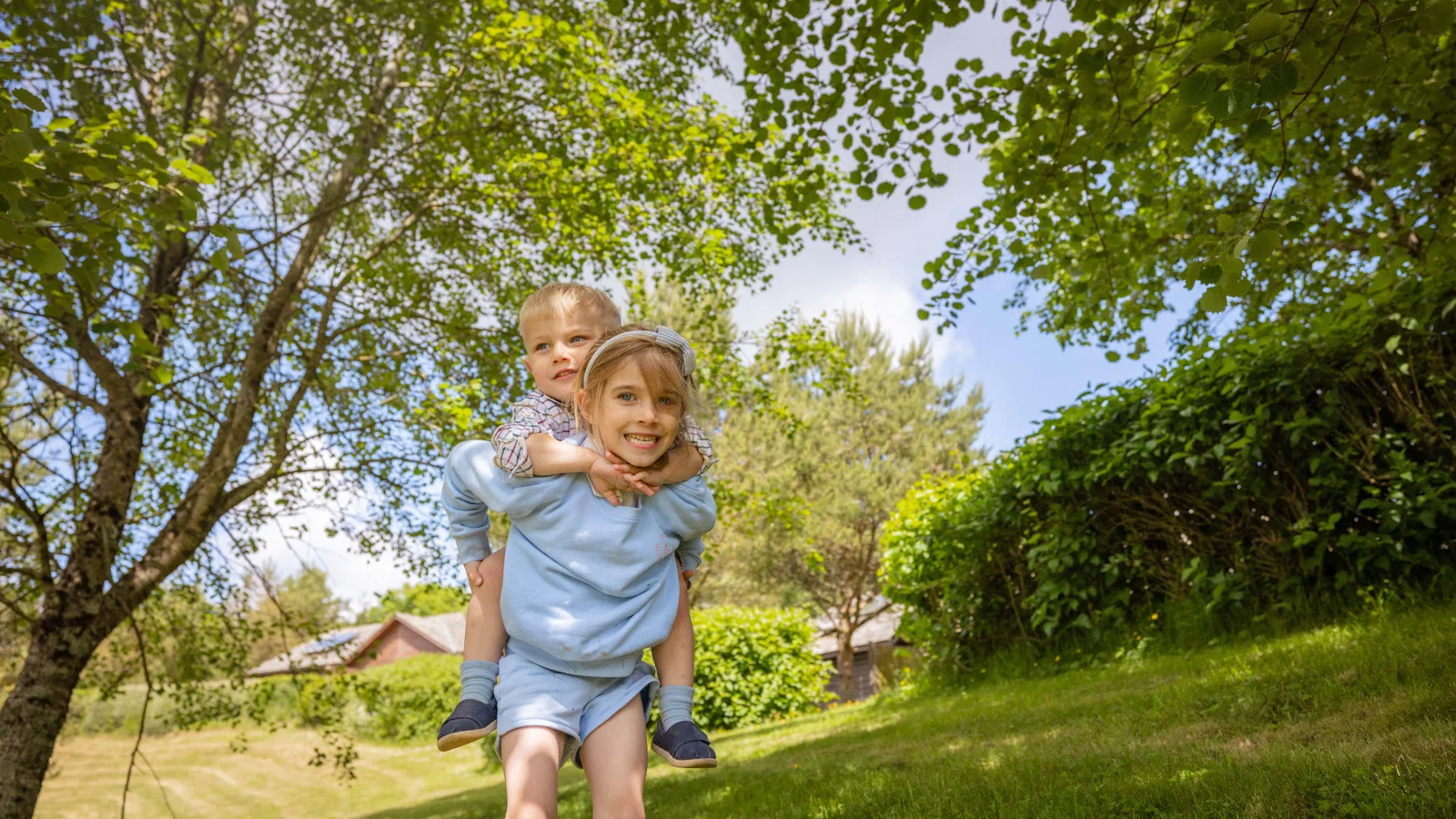 brother and sister playing outside in summer