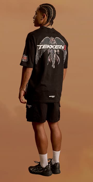 an image of a man in a black shirt and shorts standing