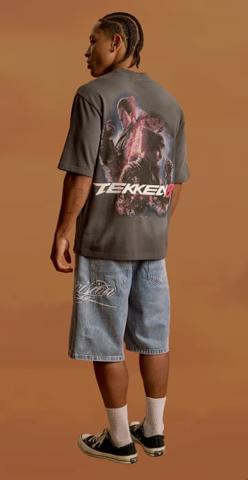an image of a man with dreadlocks standing in front of a brown background