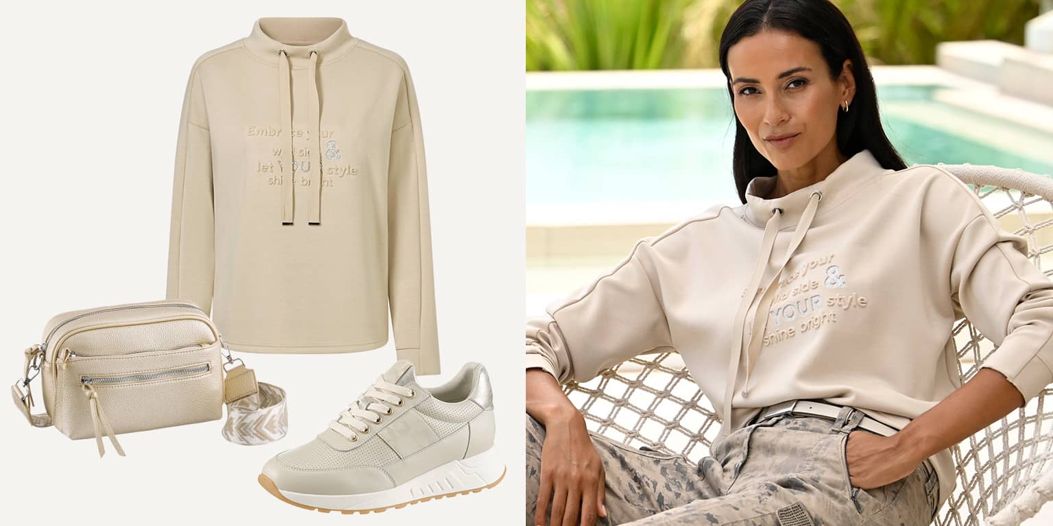Beige hoodie met tekst, gecombineerd met bijpassende schoudertas en sneakers, gedragen door een model bij het zwembad.