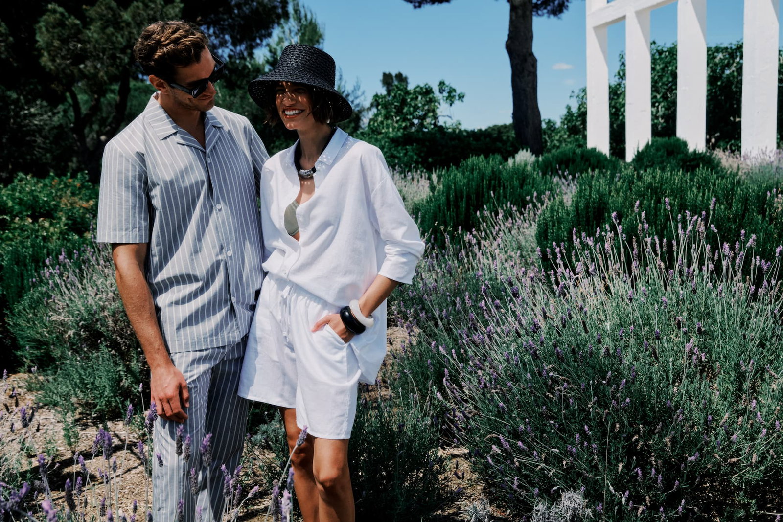 an image of a man and woman standing in a garden