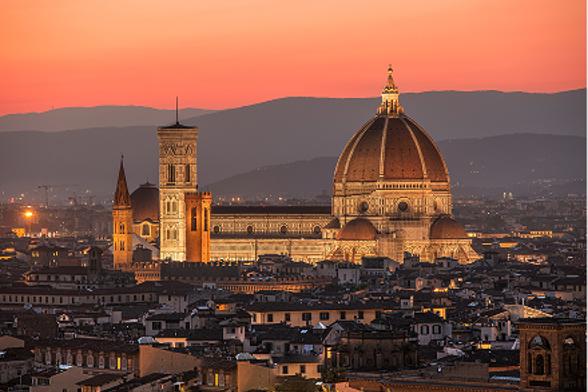 Florence cityscape at sunset with the illuminated Duomo and Giotto's Campanile.