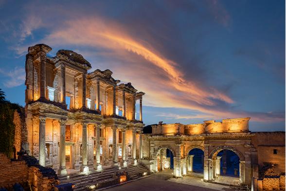 The illuminated Library of Celsus at sunset.