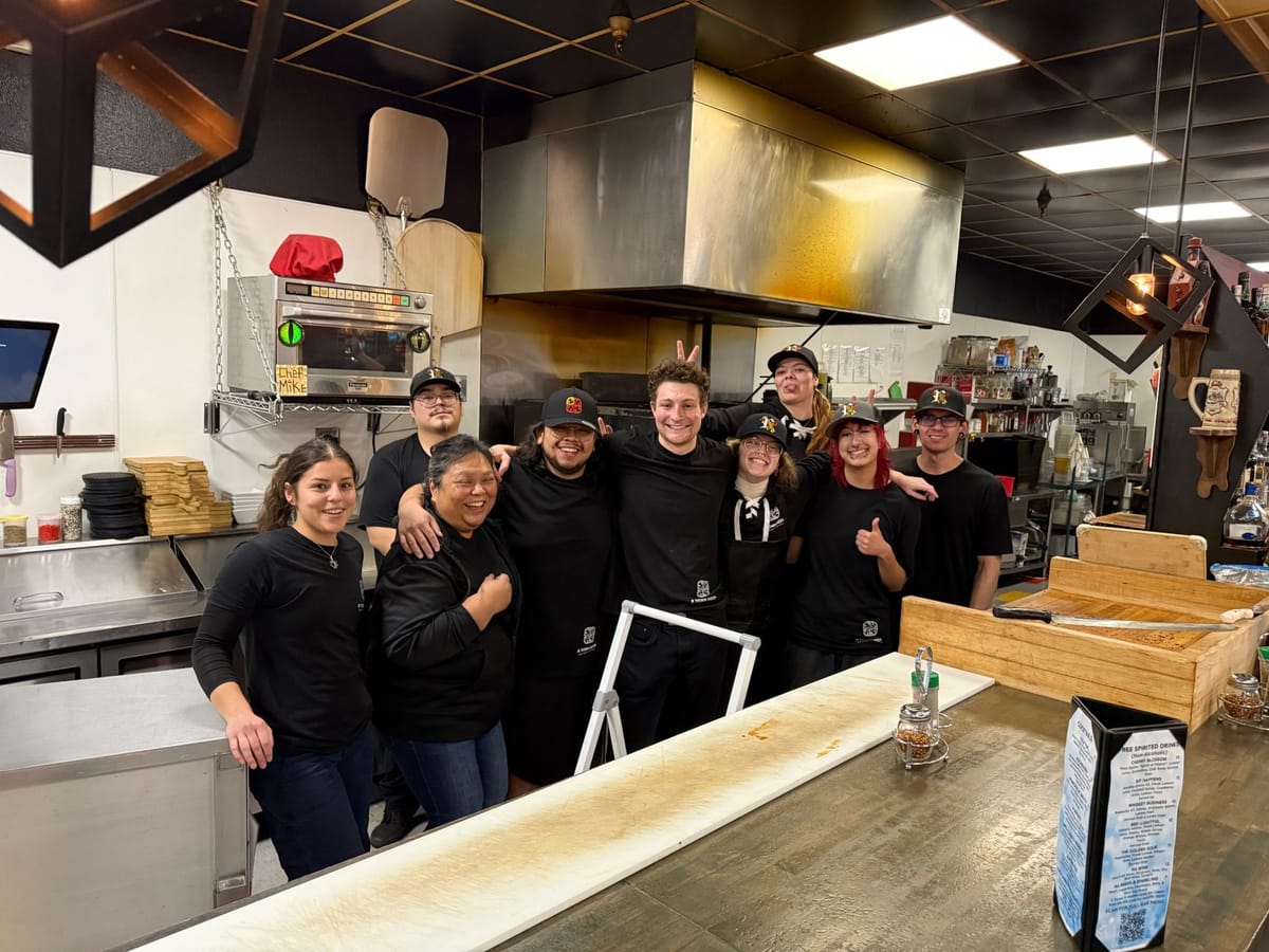 Staff at R Town Pizza in Reno, Nevada pose in the kitchen
