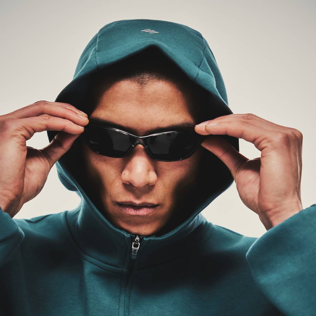Model wearing the 247 Form Zip Hoodie in Teal