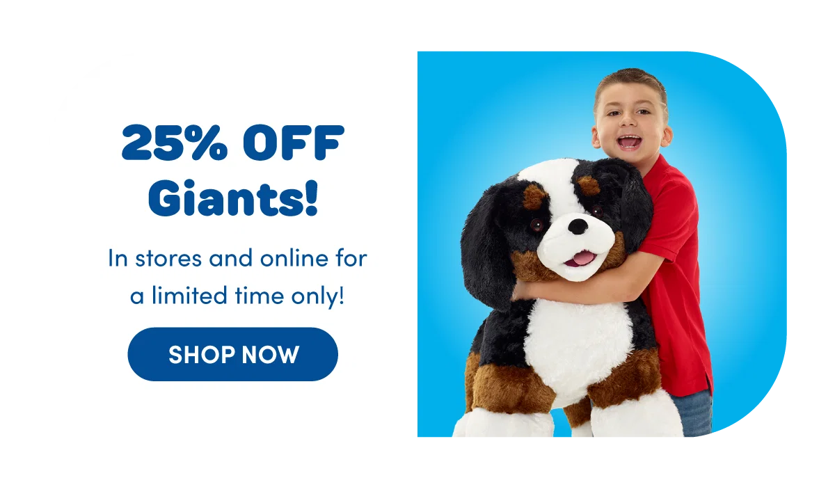 Promotional image showing a giant plush dog being hugged by a person against a bright blue background alongside text reading 25% OFF Giants, In stores and online for a limited time only, and a Shop Now button