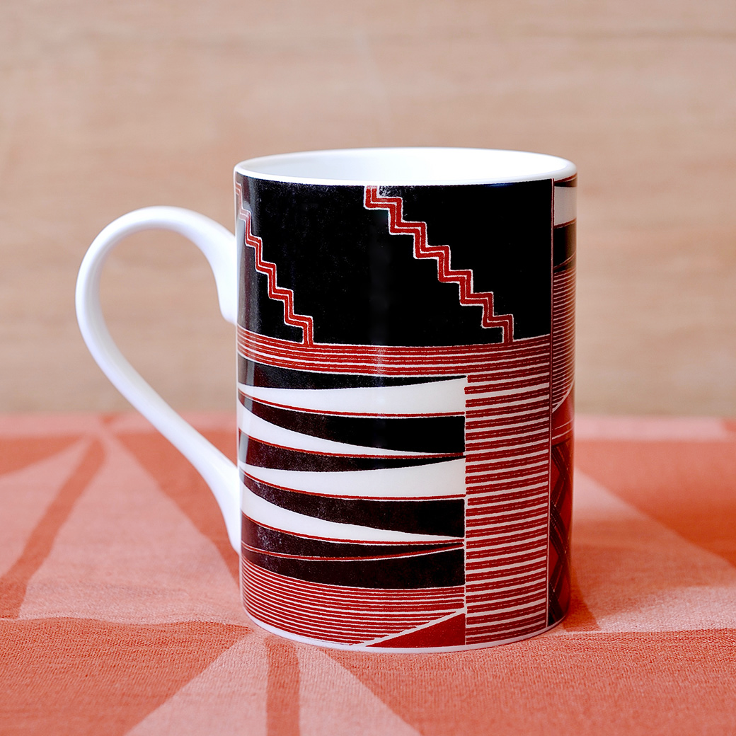 Bone china mug decorated with geometric patterns in brown, black and white, inspired by 18th-century Hawaiian kapa. - Shop the Range.
