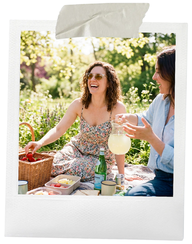 A woman wearing Axon Optics powered by Avulux glasses while outside having a picnic.
