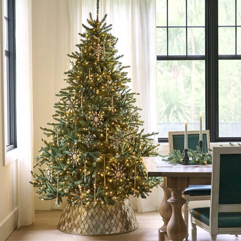 Picture of a christmas tree in a brightly lit dining room