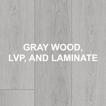 Gray Wood, LVP, and Laminate. Broad planks of pale gray woodgrain, featuring intricate knots and subtle textures, convey timeless elegance and understated modernity.