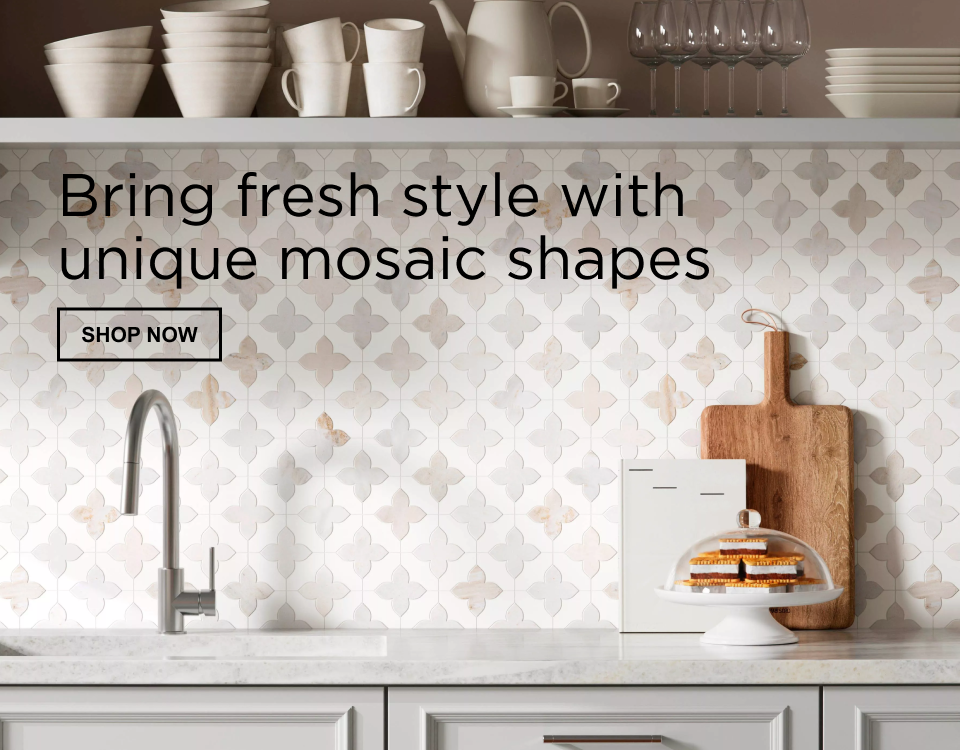 Bring fresh style with unique mosaic shapes. Shop Now. A serene kitchen vignette featuring patterned white tile, sleek fixtures, warm wood accents, and soft-hued ceramics against an airy pastel backdrop.