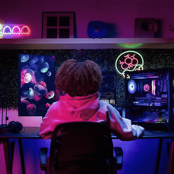 gamer putting on headphones in front of her setup